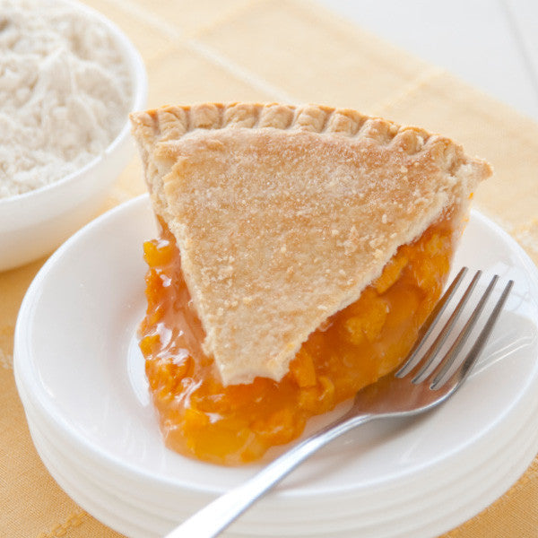 Juicy golden peaches are cooked perfectly in a blonde filling with a delicious result. Our double-crusted fruit pies are lightly brushed with butter and sprinkled with sugar to brown the crust. Pies will arrive pre-baked and frozen in an insulated shipping cooler. Simply thaw in the oven and your home will be filled with the sweet scent of our Amish bakery. Instructions are included.
Available as 9 inch pie. Baked and shipped from Ohio's Amish Country.